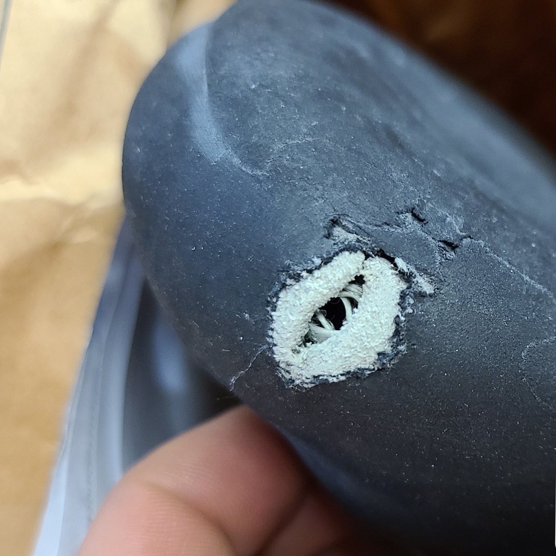 a climbing shoe that has been worn beyond repairability with the rubber and leather worn through