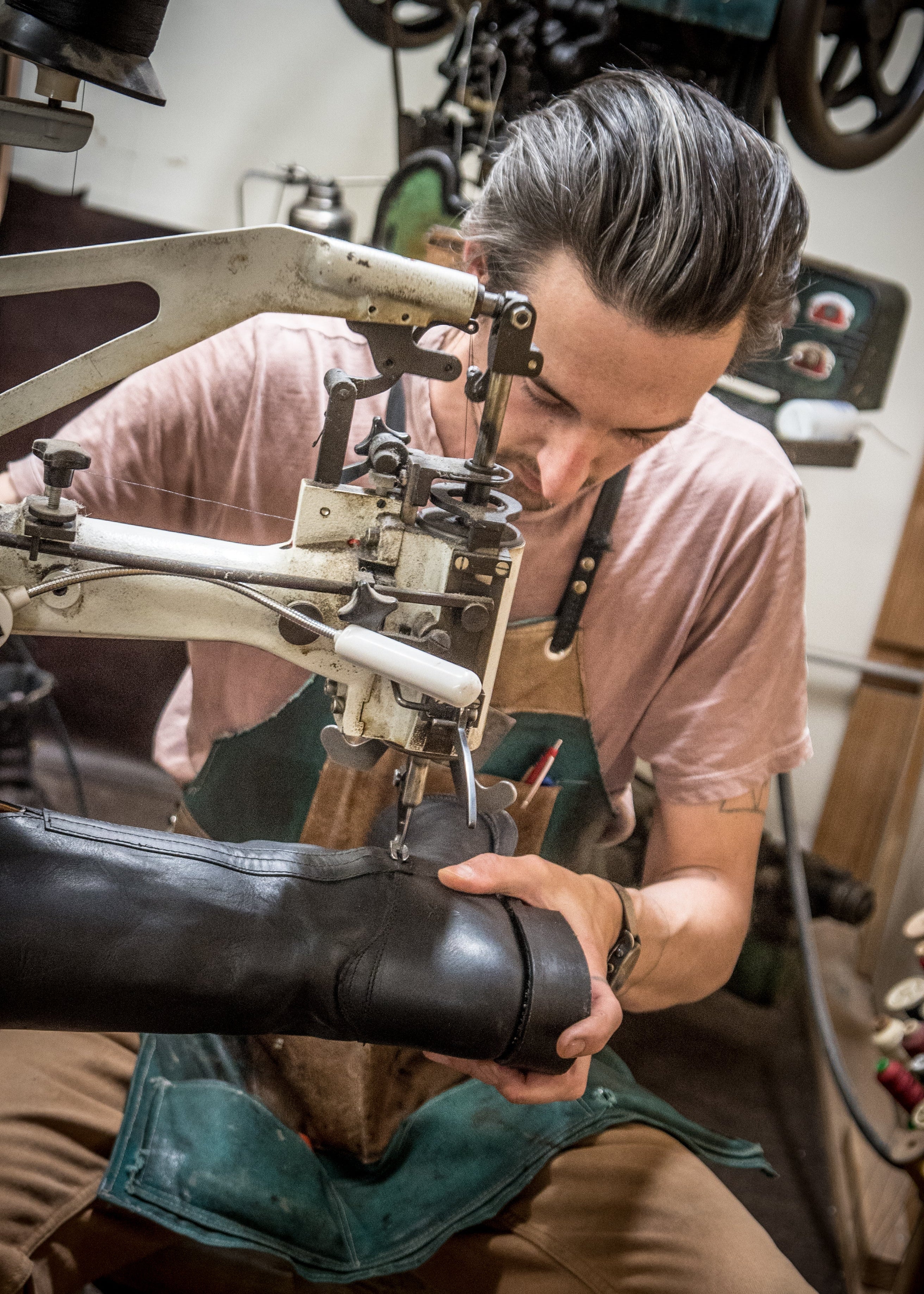 Person working on a shoe in a workshop setting